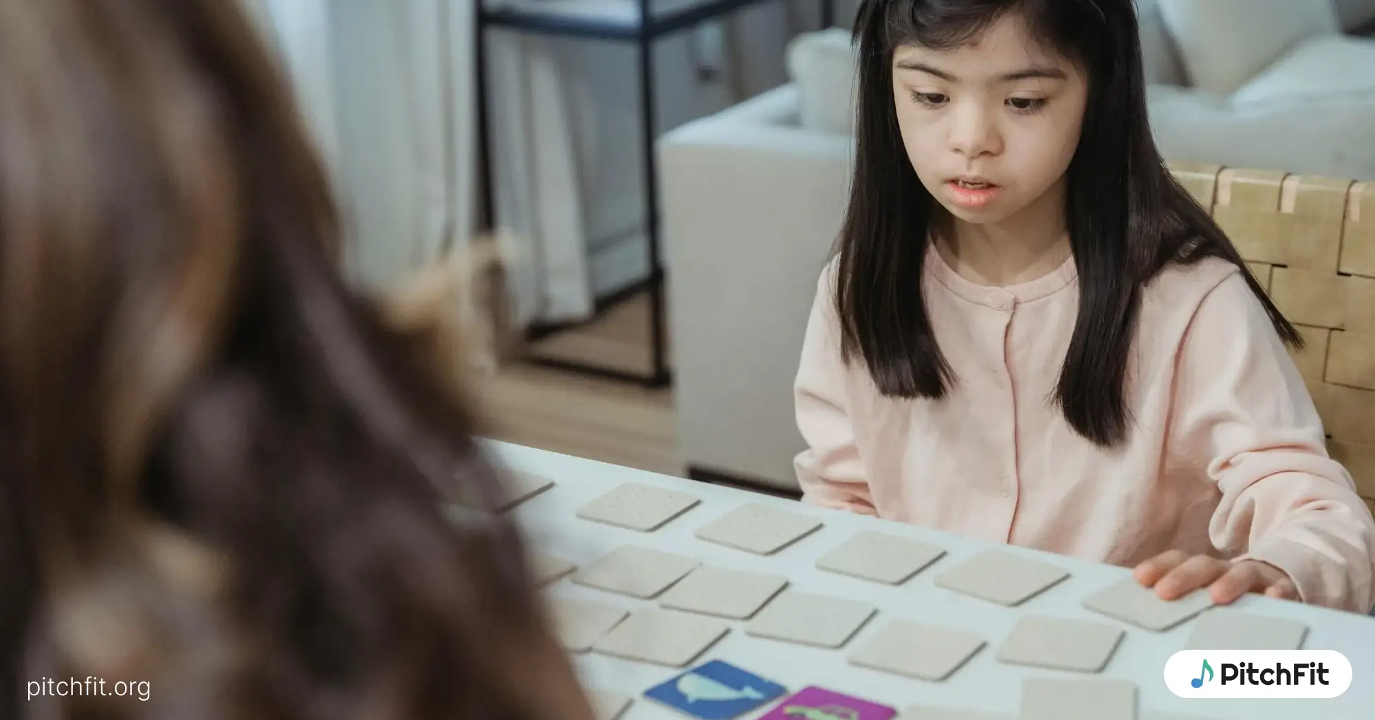 A young autistic child playing a memory game